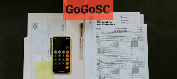 black Android smartphone near ballpoint pen, tax withholding certificate on top of white folder