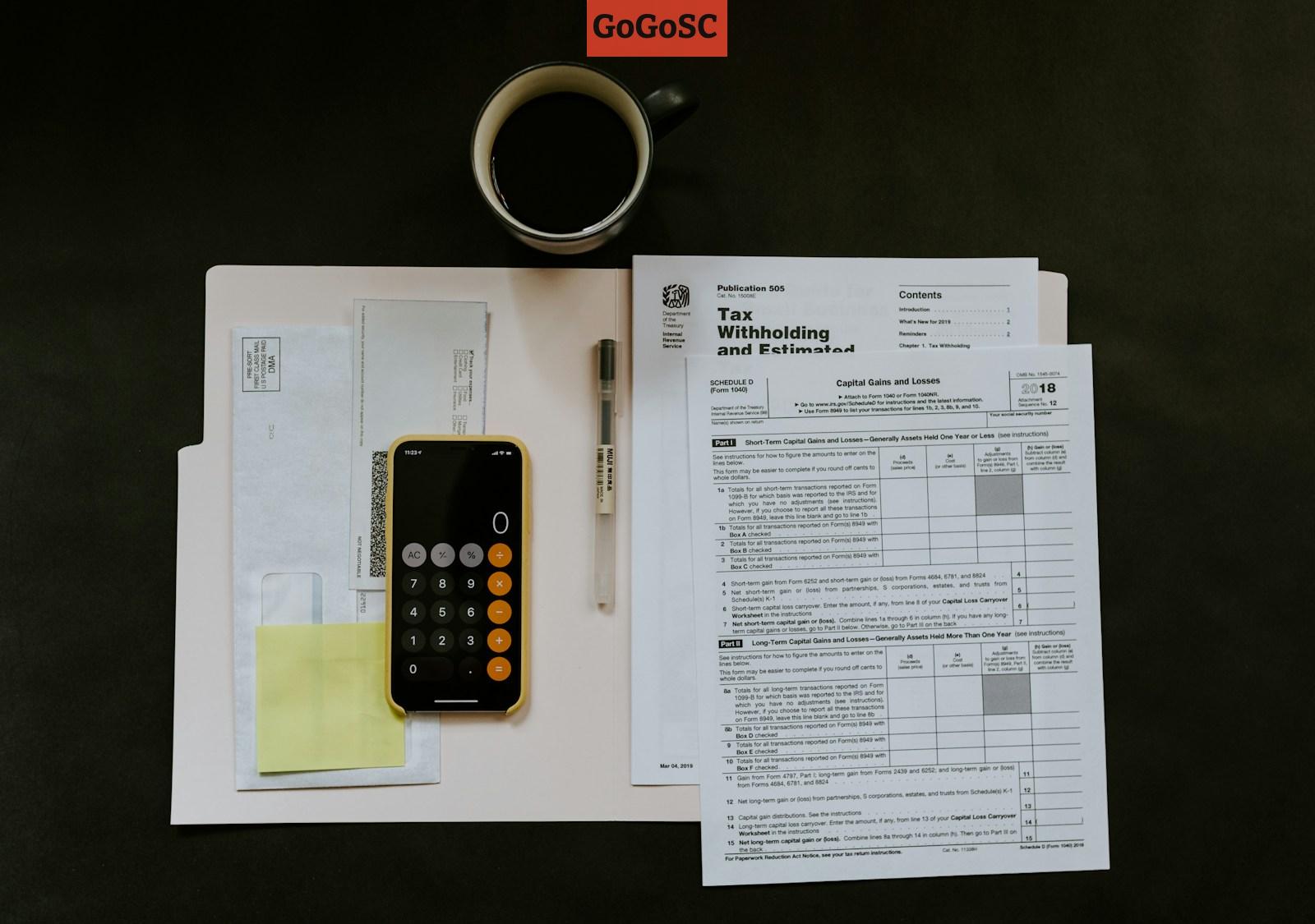 black Android smartphone near ballpoint pen, tax withholding certificate on top of white folder
