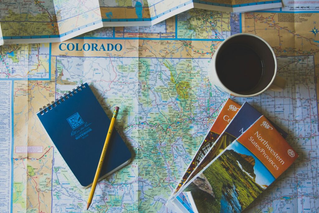Mapa del mundo con pasaporte y cámara sobre una mesa para planificar un viaje